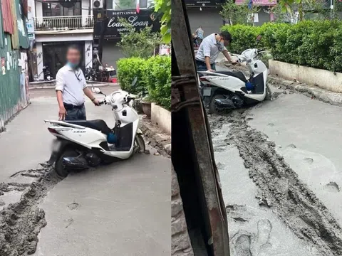 Bất chấp cảnh báo, người đàn ông cố dắt xe vào ngõ mới đổ bê tông ở Hà Nội: "Tiện đường" là lý do?